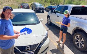 People standing with cars during a CGBN-YV assessment