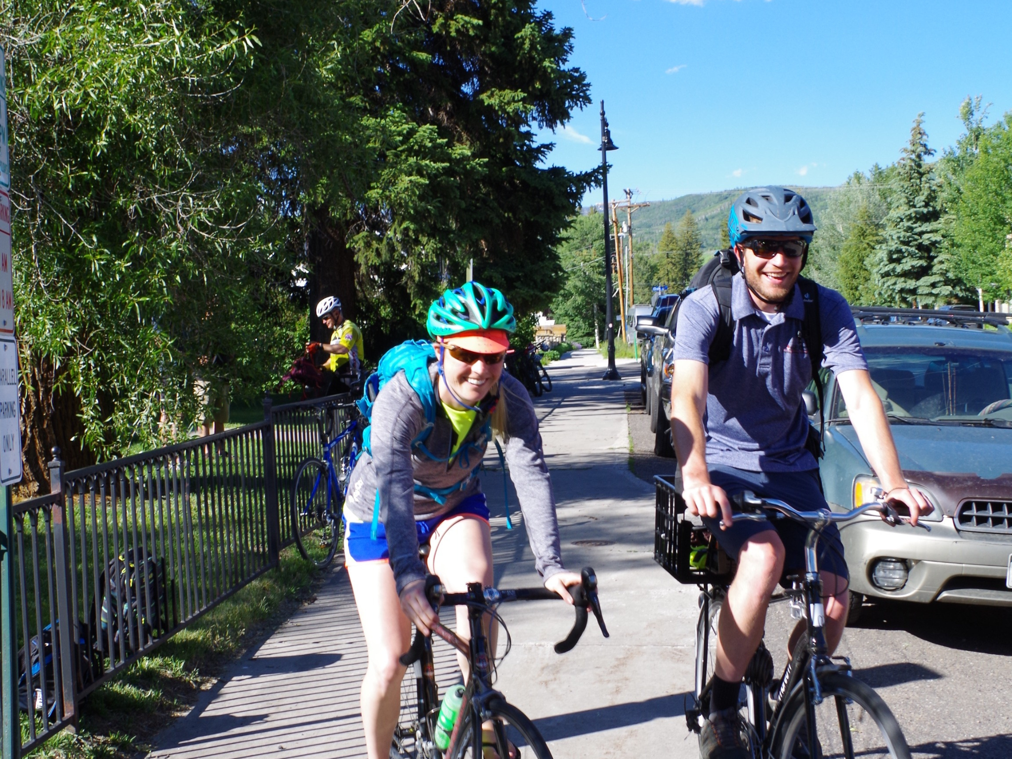 Two people riding bikes and smiling